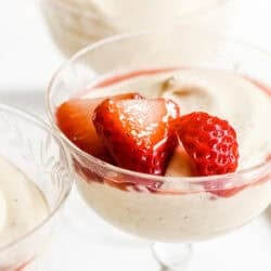 Creamy white chocolate mousse topped with macerated strawberries and juice.