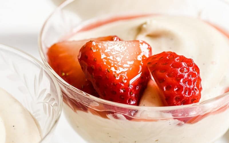 Creamy white chocolate mousse topped with macerated strawberries and juice.