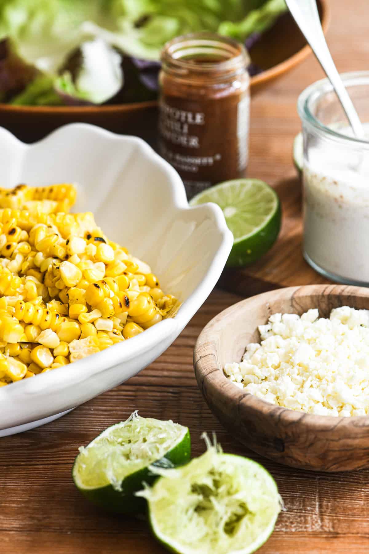 Making Mexican corn salad in a white bowl/
