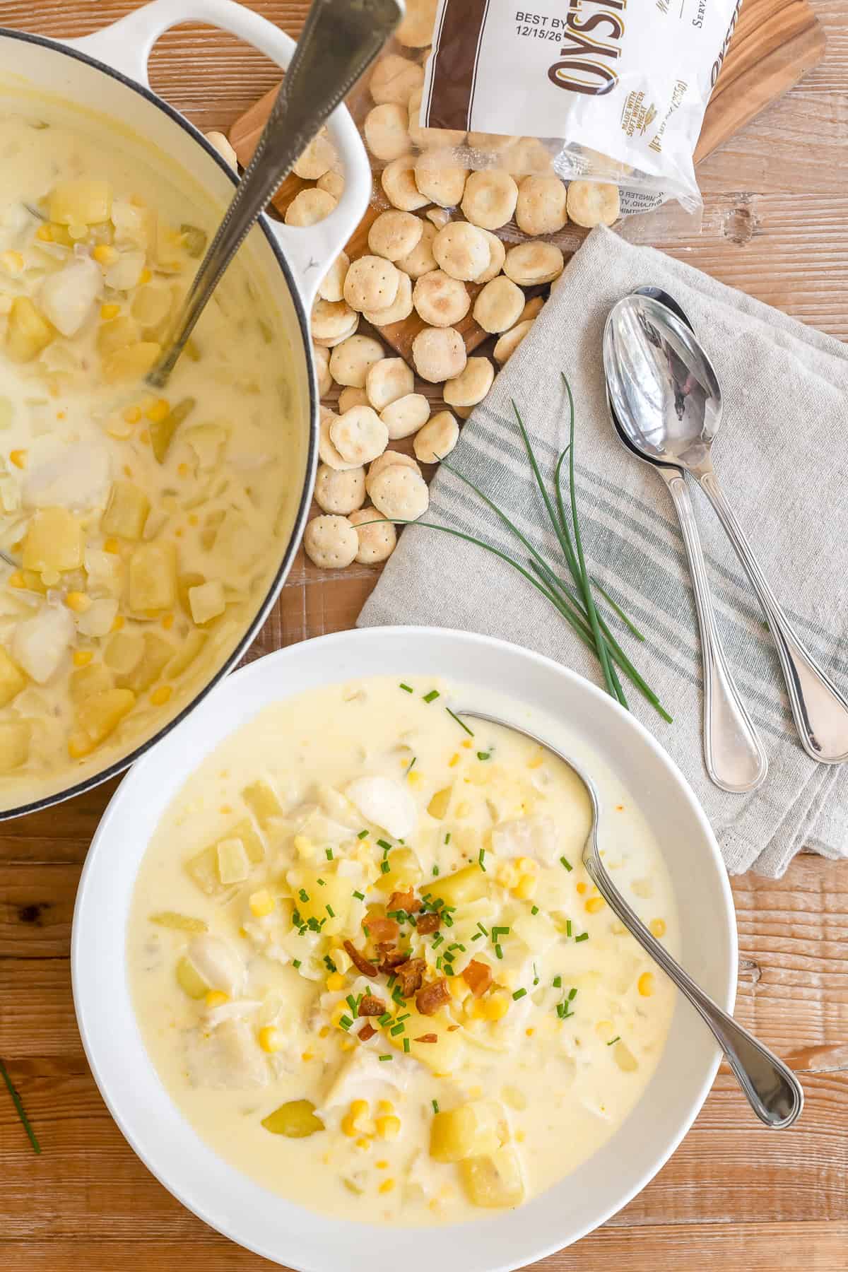 New England fish chowder in a bowl with bacon and chives.