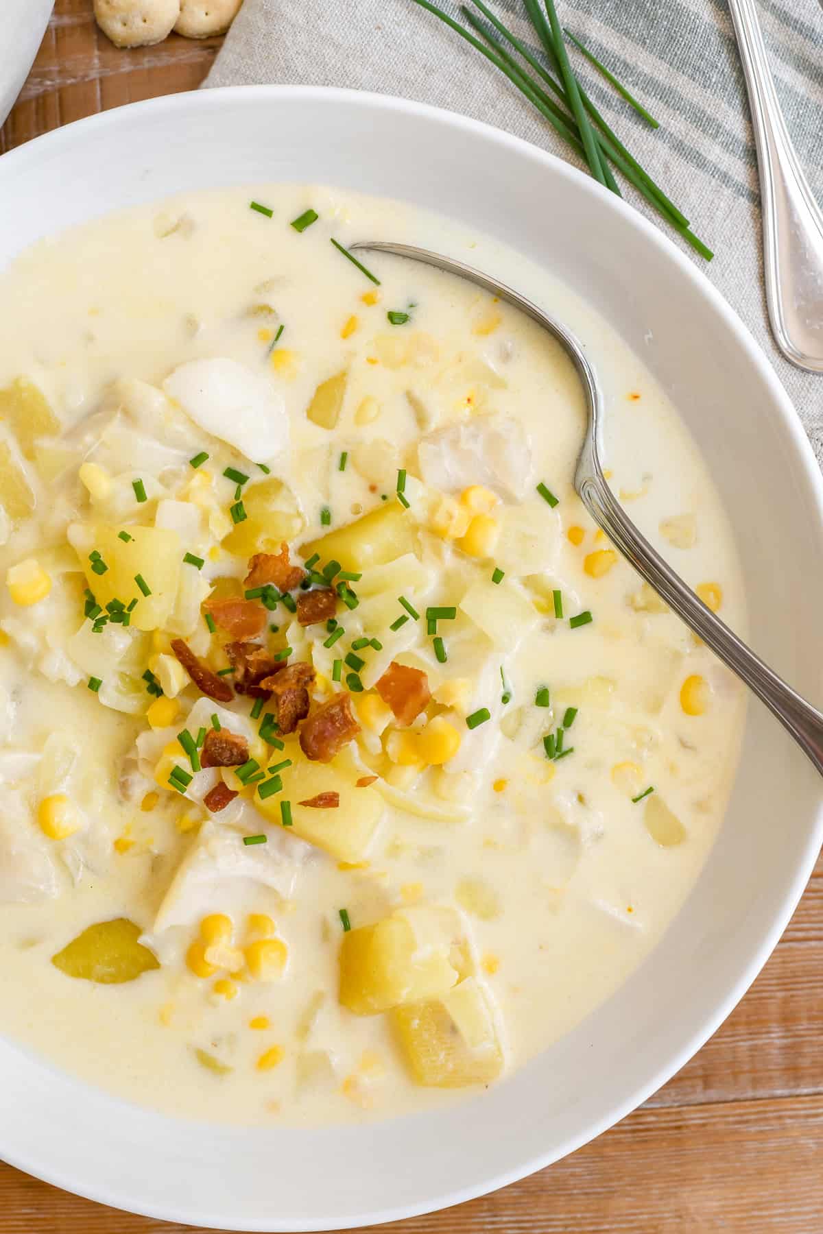 A bowl of New England fish chowder with spoon.