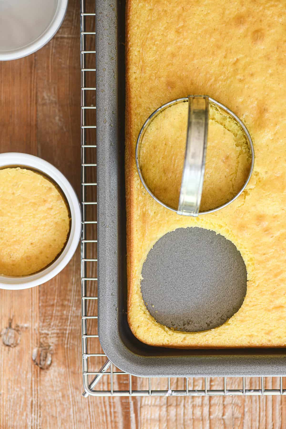 Cutting out circles of cake to fit into small ramekins for dot cake.