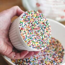 A lemon dot cake covered with a layer of sprinkles.