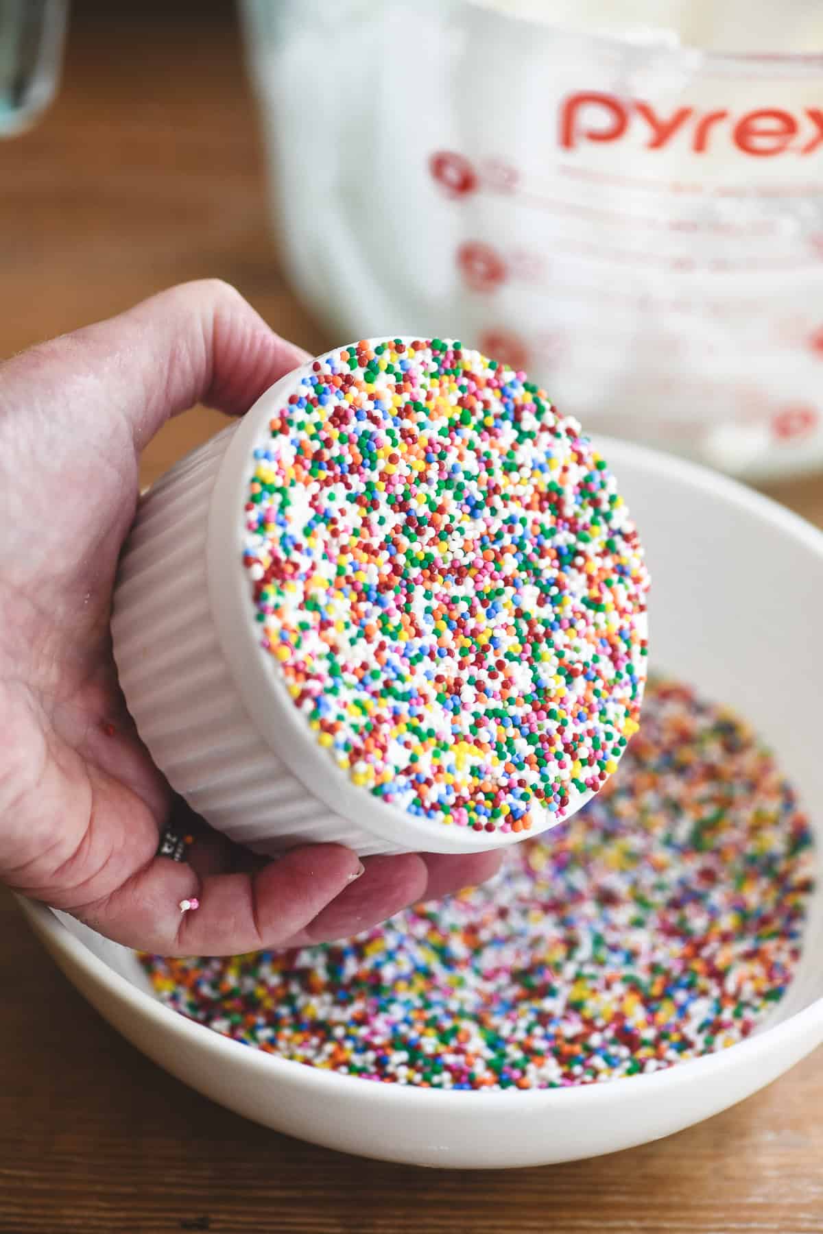 A lemon dot cake covered with a layer of sprinkles.