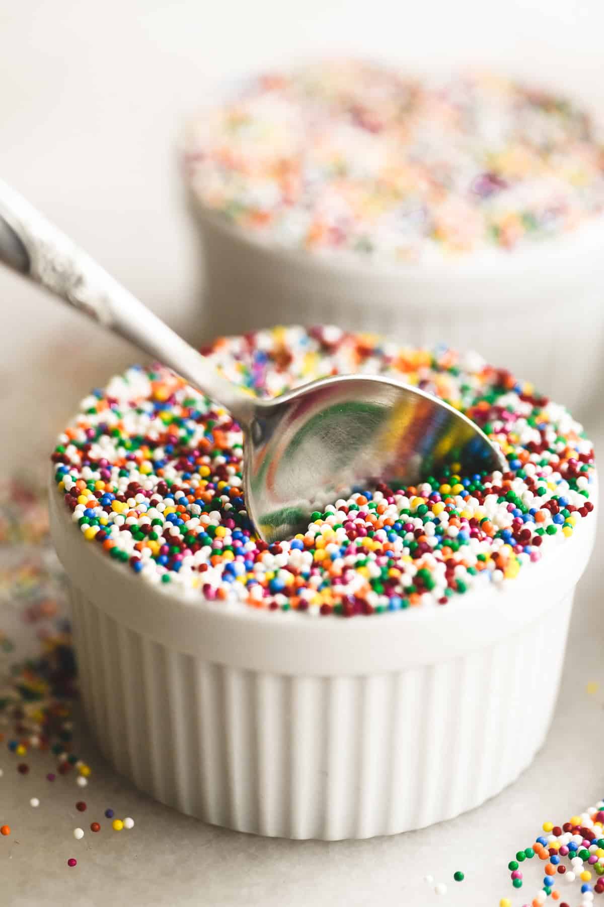 A spoon taking a bite of a lemon dot cake.