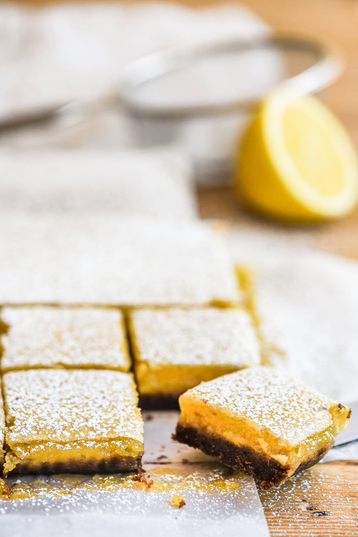 Black bottom lemon bars, sliced and topped with powdered sugar.