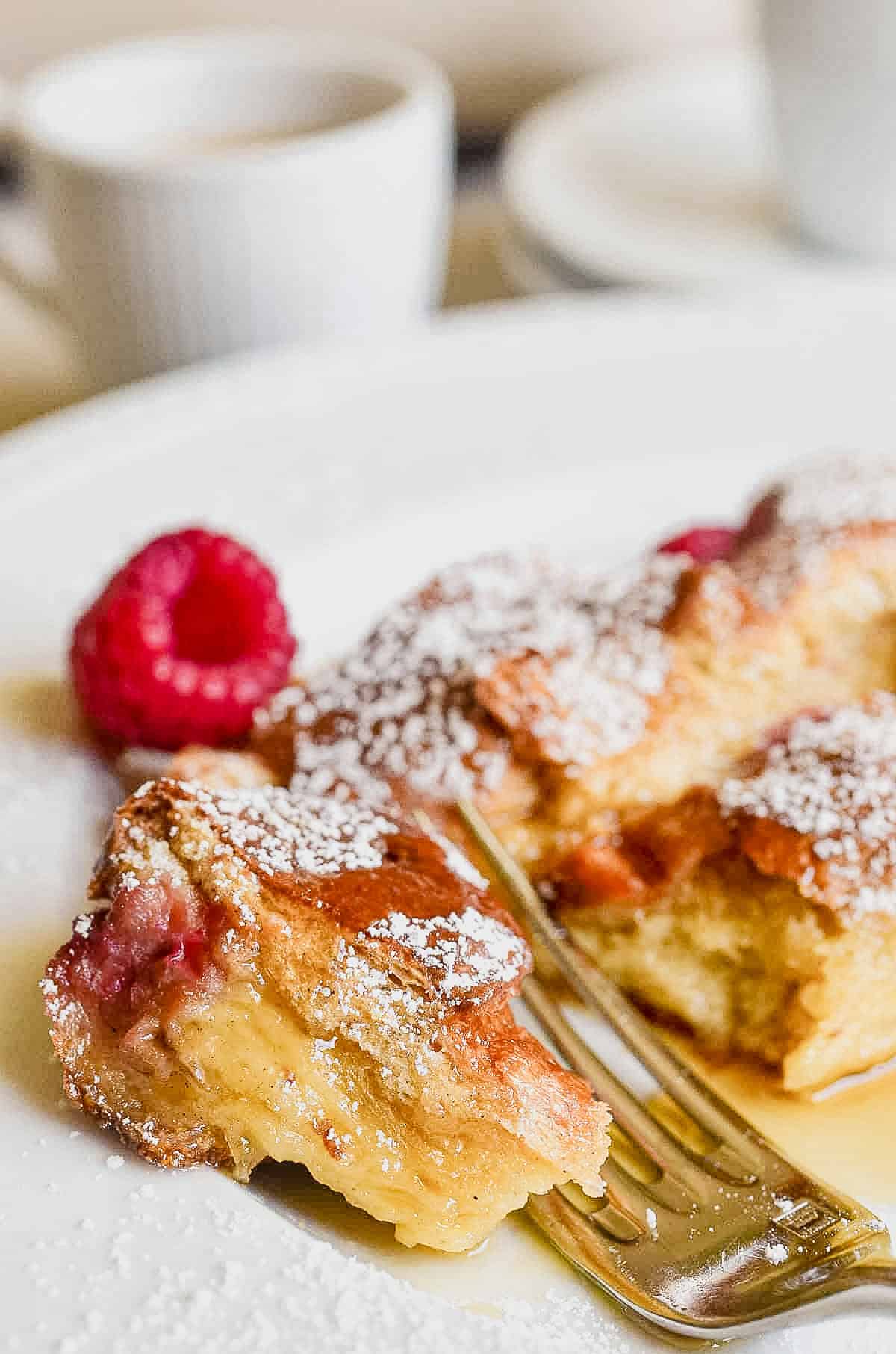 Taking a bite of Raspberry Baked French toast.