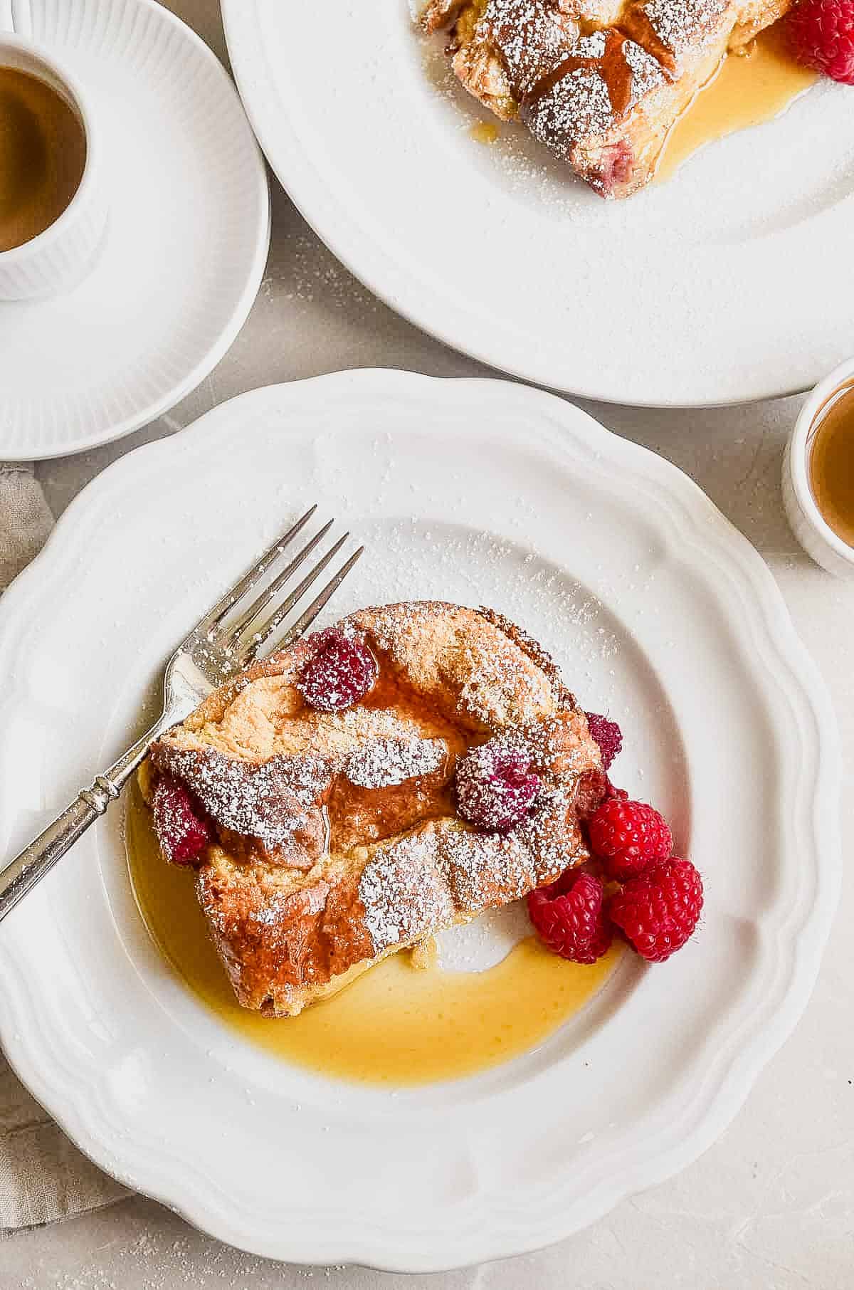 Raspberry Baked French Toast on a plate with syrup.