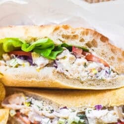 Smoked trout salad sandwich with chips.