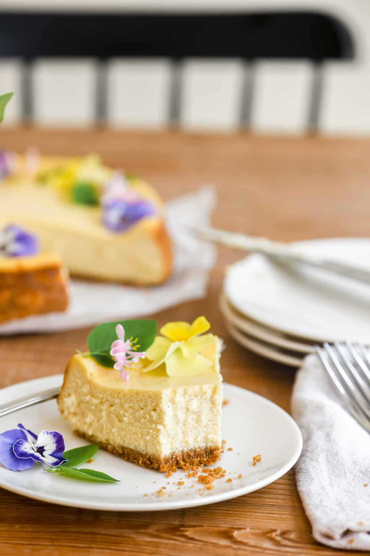 A piece of vanilla bean cheesecake with bites taken.