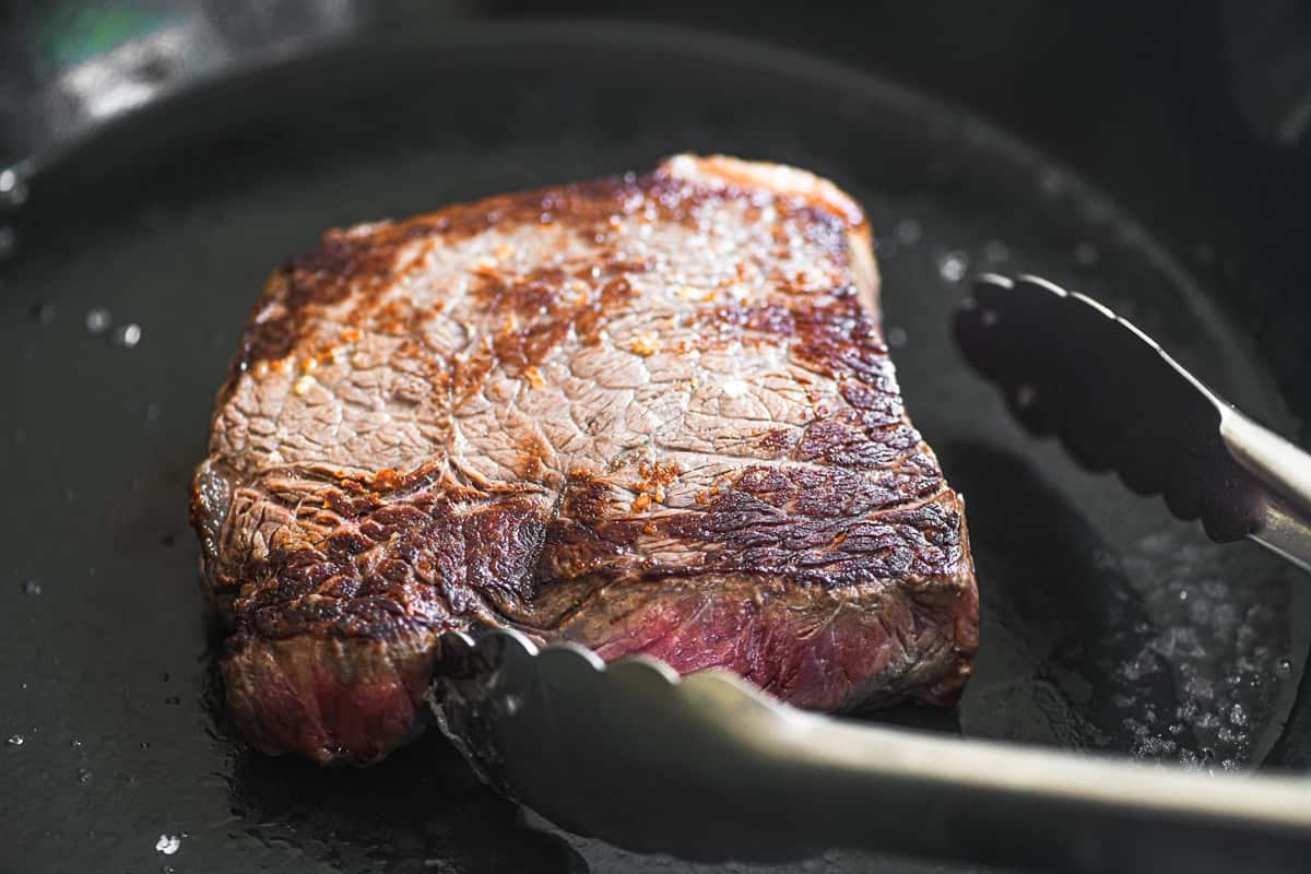 searing top sirloin steak for steak salad.