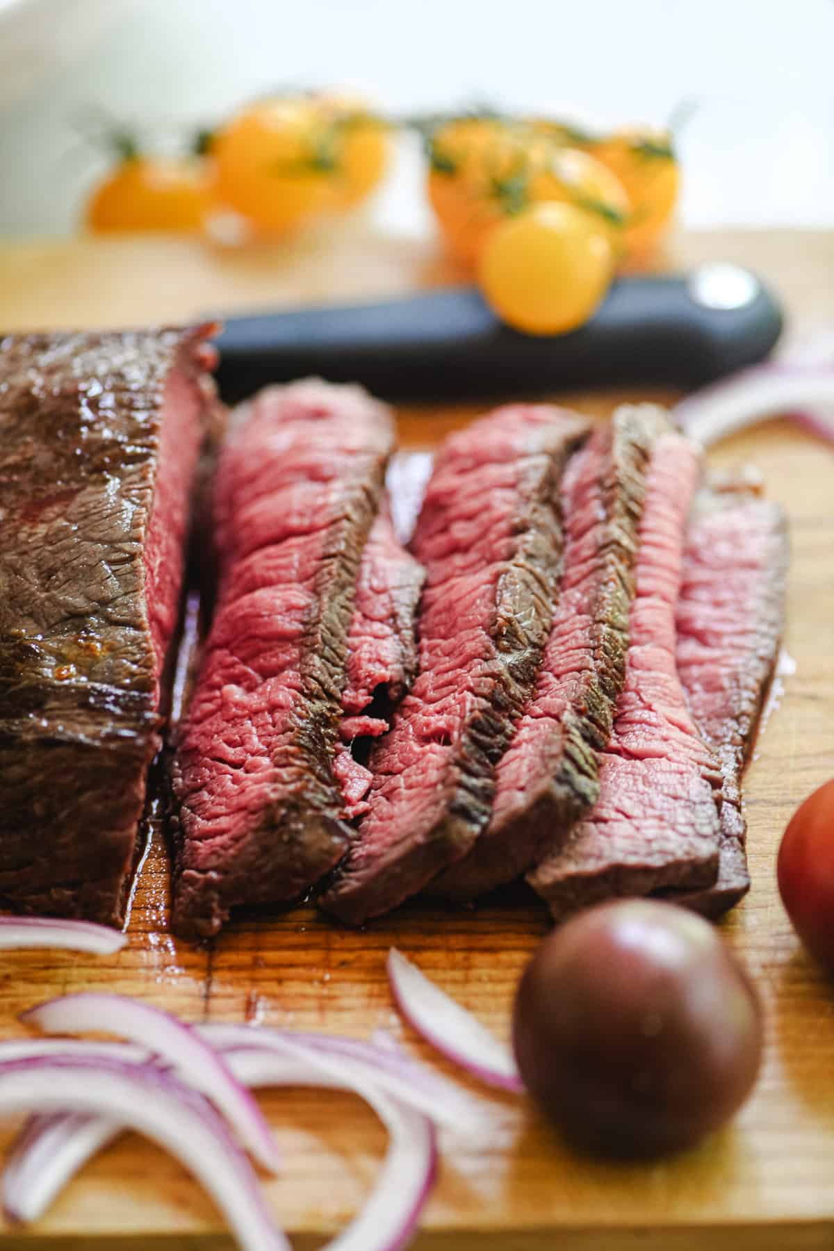 slicing medium rare steak for steak salad.