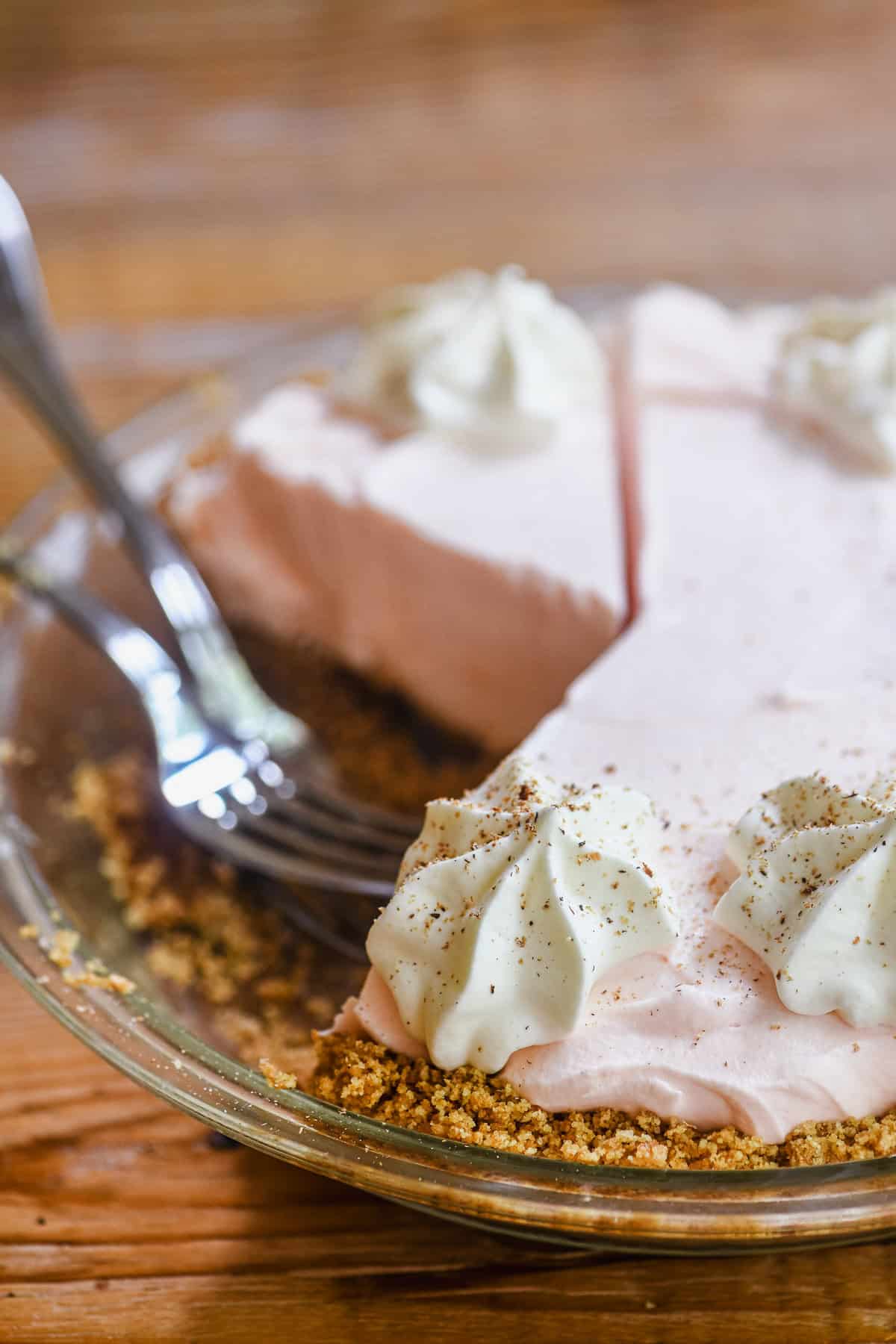 Frozen Pink Squirrel Pie with slices taken, and forks.