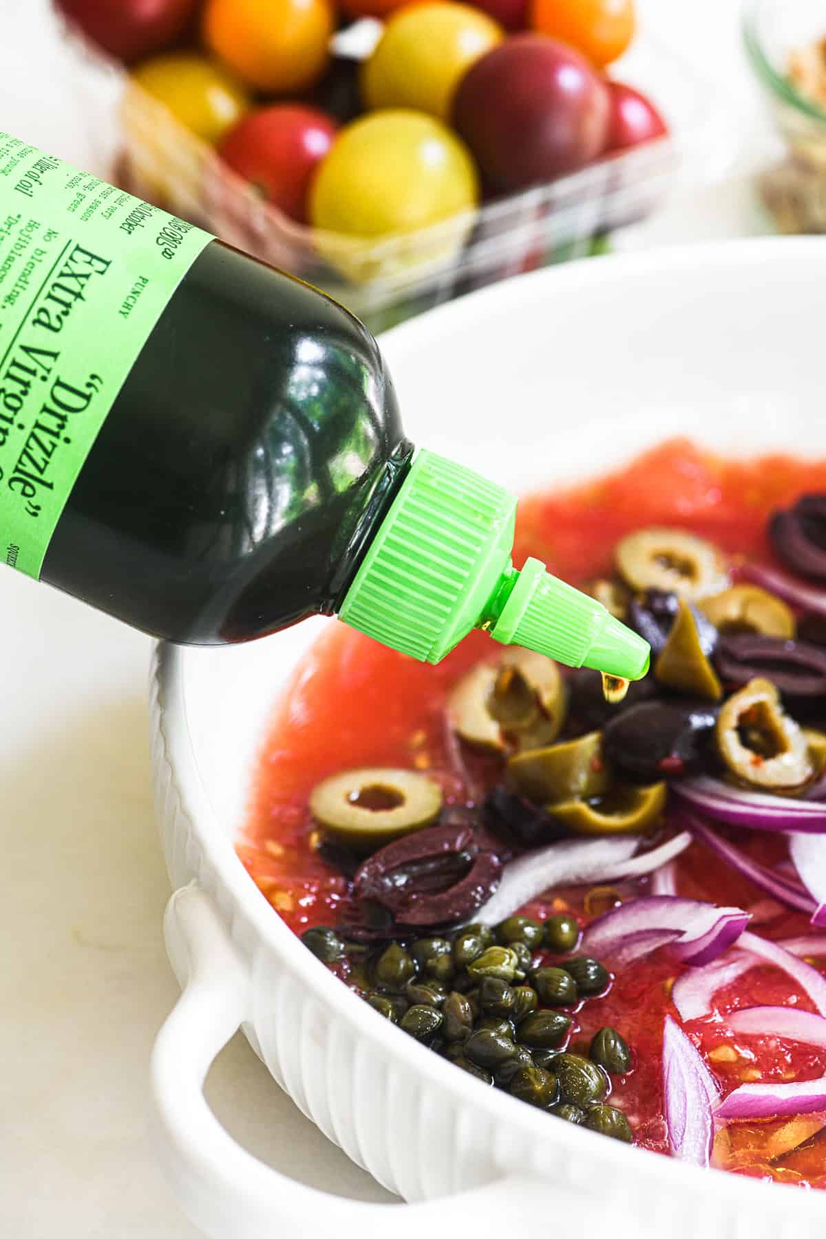 Drizzling olive oil into a no-cook tomato sauce for pasta.