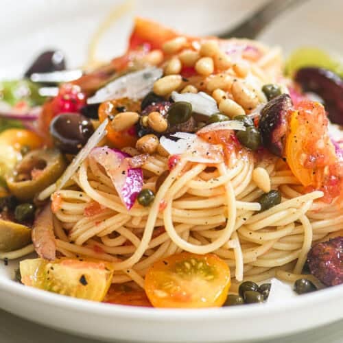 A bowl of spaghetti with no-cook Mediterranean pasta sauce.