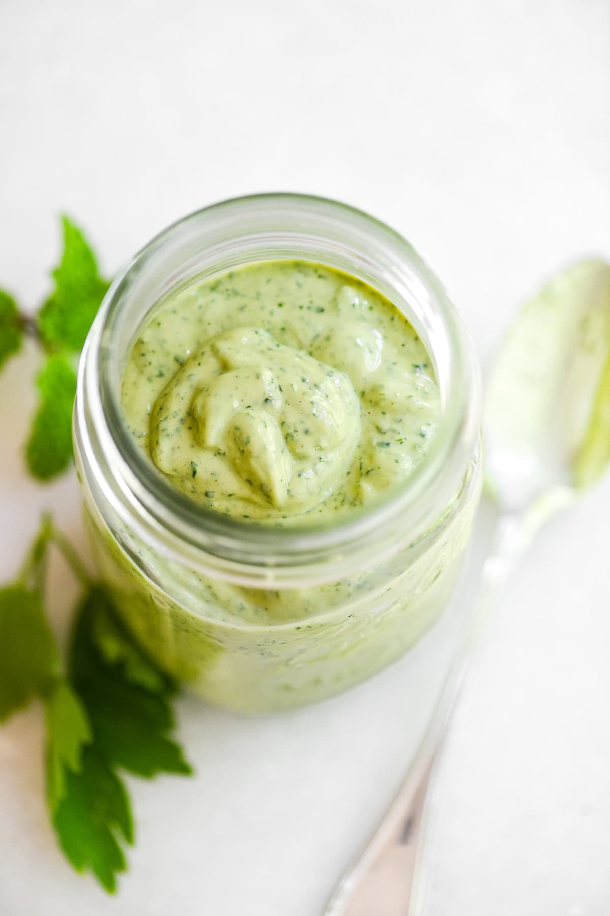 green tahini sauce in a jar.