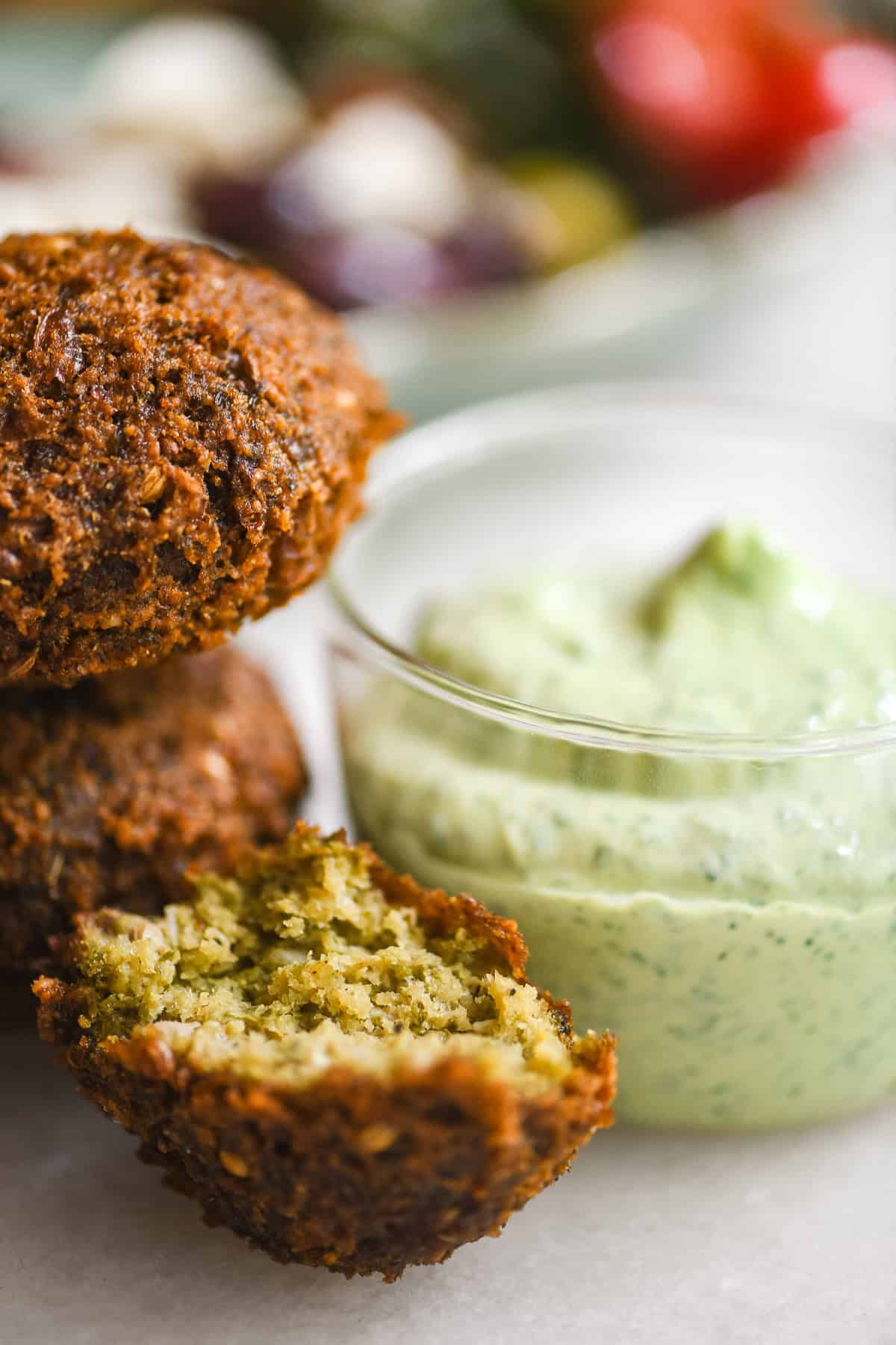 Falafel with a small bowl of green tahini sauce.