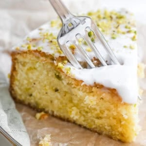 Taking a bite of a slice of lemon pistachio cake.