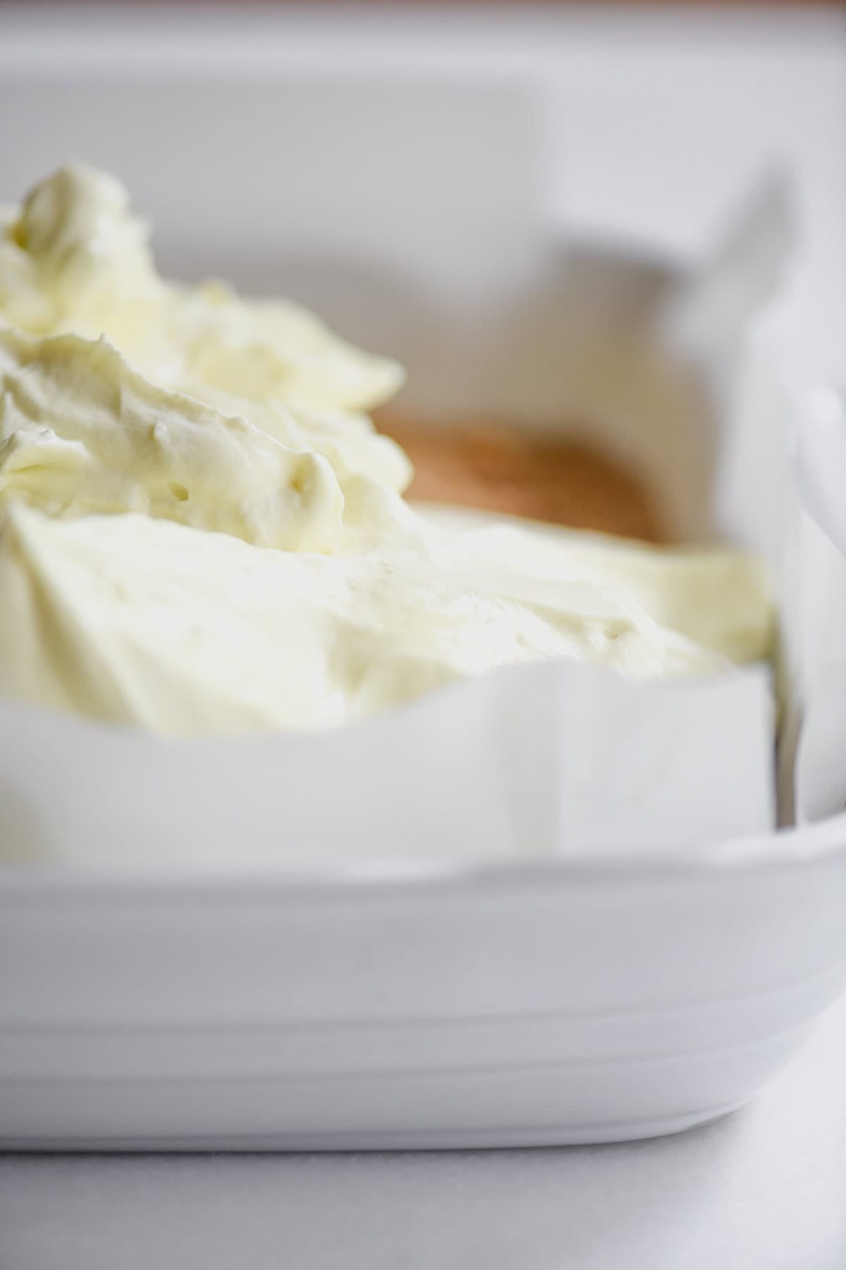 spreading frozen limonada filling into pan.