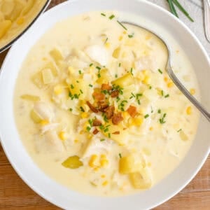 A vowl of classic New England Fish Chowder topped with bacon and oyster crackers.