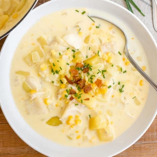 A vowl of classic New England Fish Chowder topped with bacon and oyster crackers.