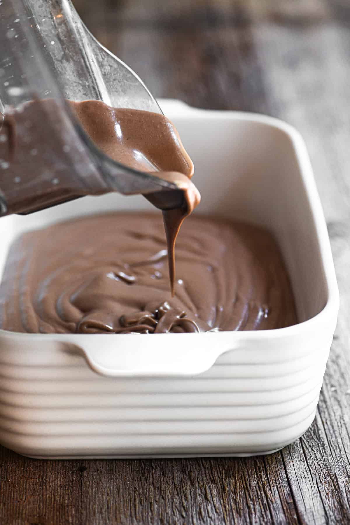 Pouring blender no churn Nutella ice cream into a pan.