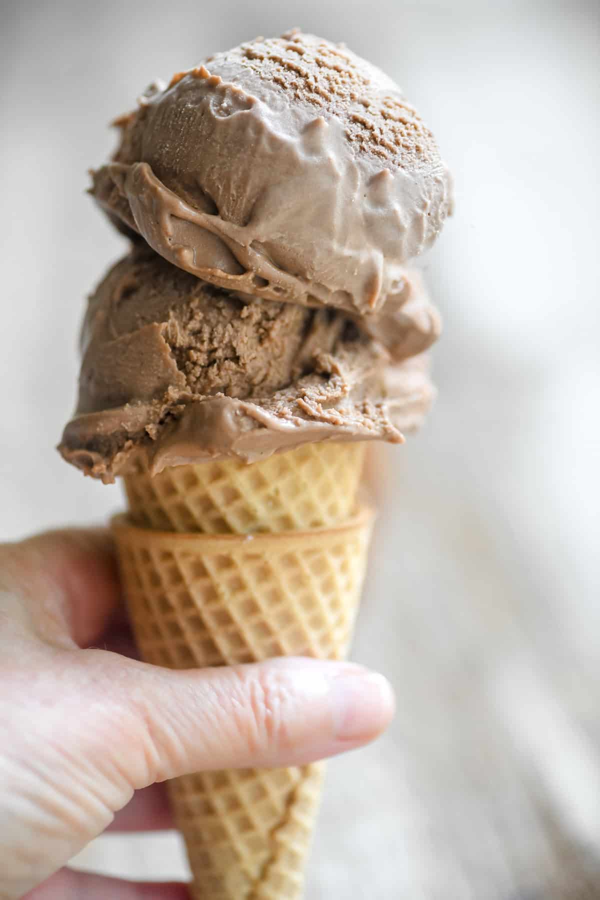 Holding a double scoop no-churn Nutella ice cream cone.