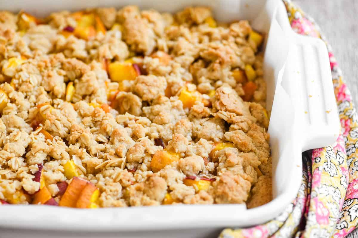 a pan of spiced peach cobbler bars, just out of the oven.
