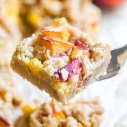Juicy spiced peach crumb bar, on a fork.