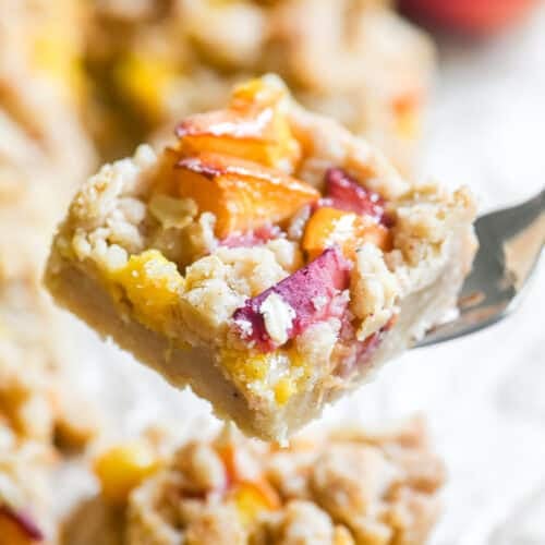 Juicy spiced peach crumb bar, on a fork.