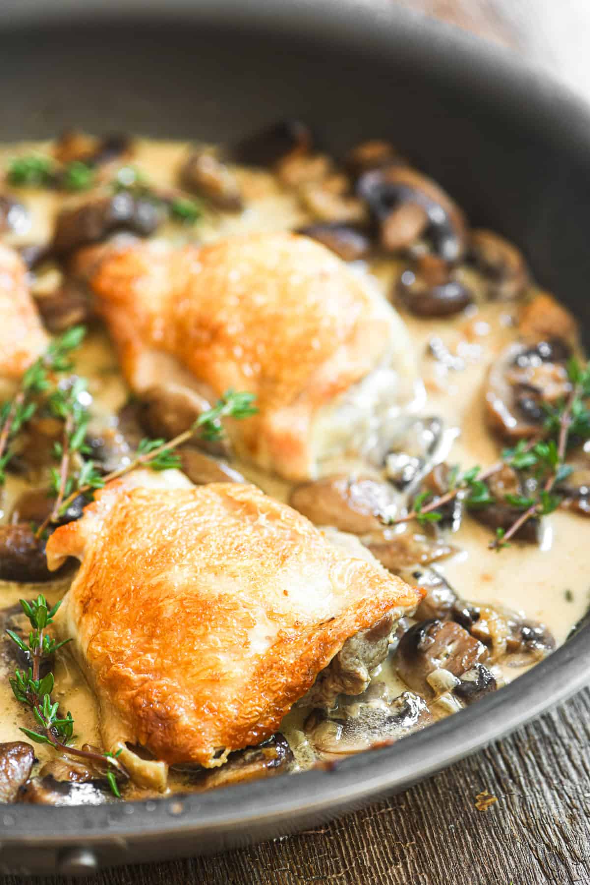 chicken thighs braising in a mushroom marsala sauce.