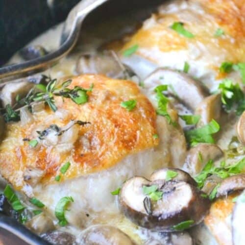 chicken thighs in a creamy marsala sauce in a cast iron skillet.