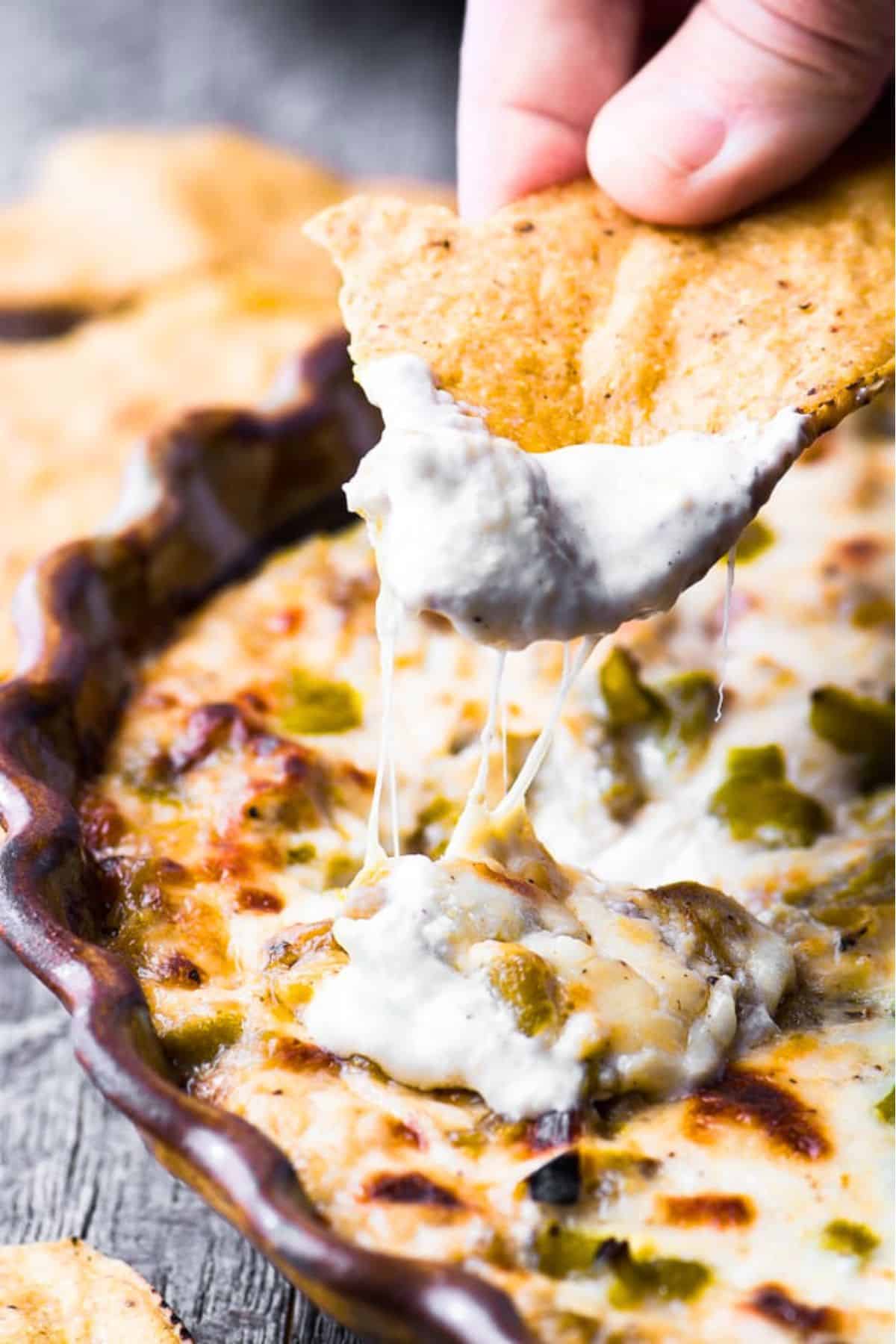 Dipping a tortilla chip into Hatch Chile Dip.