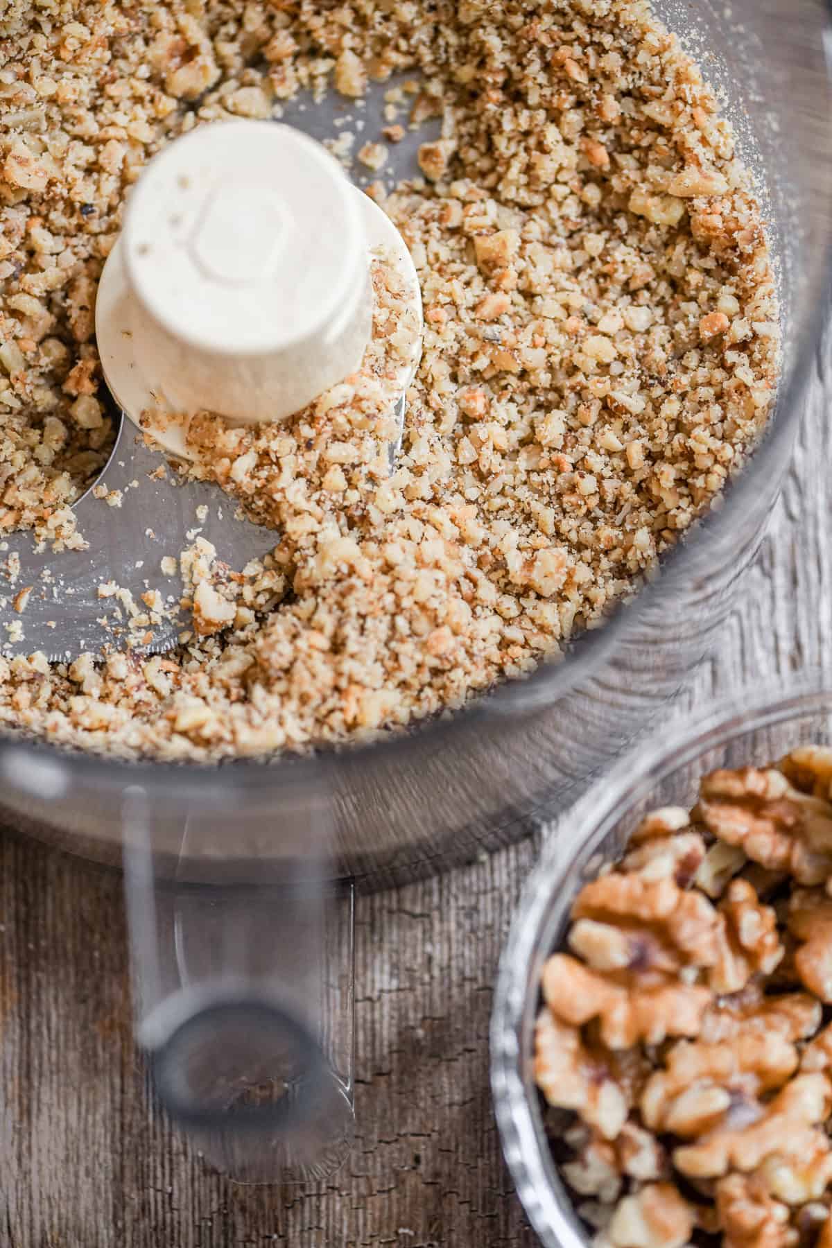 Chopped toasted walnuts in a food processor.