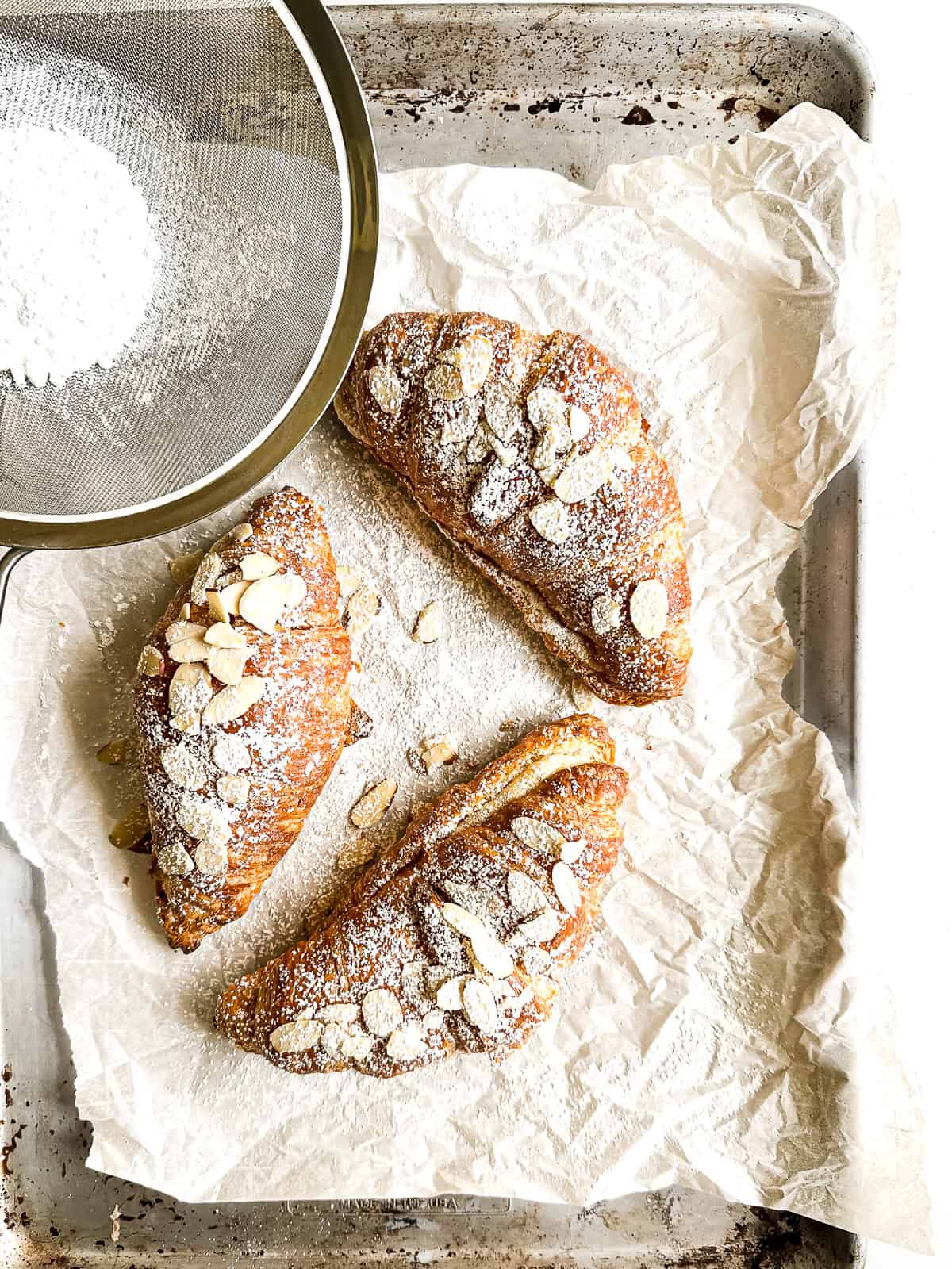 Almond croissants dusted with powdered sugar.