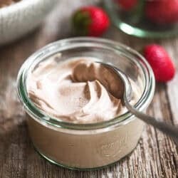 A small jar of chocolate hazelnut yogurt with spoon.