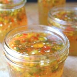 Golden hot pepper jelly in small glass jars.
