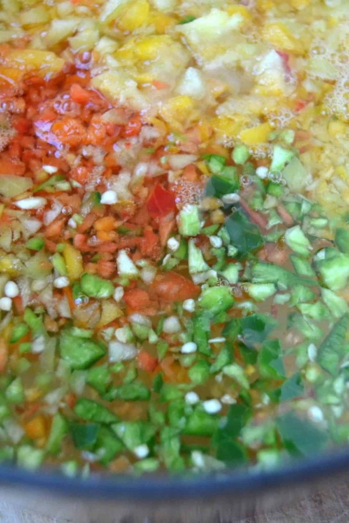making hot pepper jelly with colorful minced peppers.
