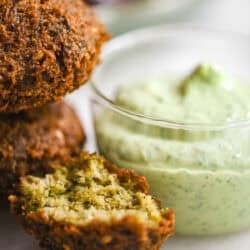 falafel alongside a jar of creamy green tahini.