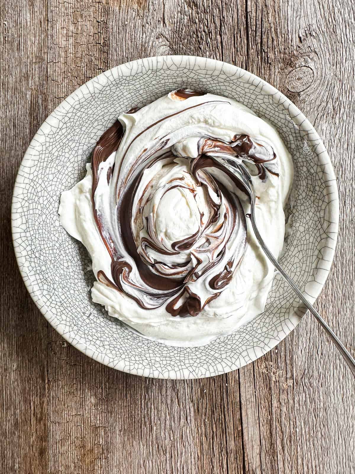 Mixing yogurt with chocolate hazelnut spread.