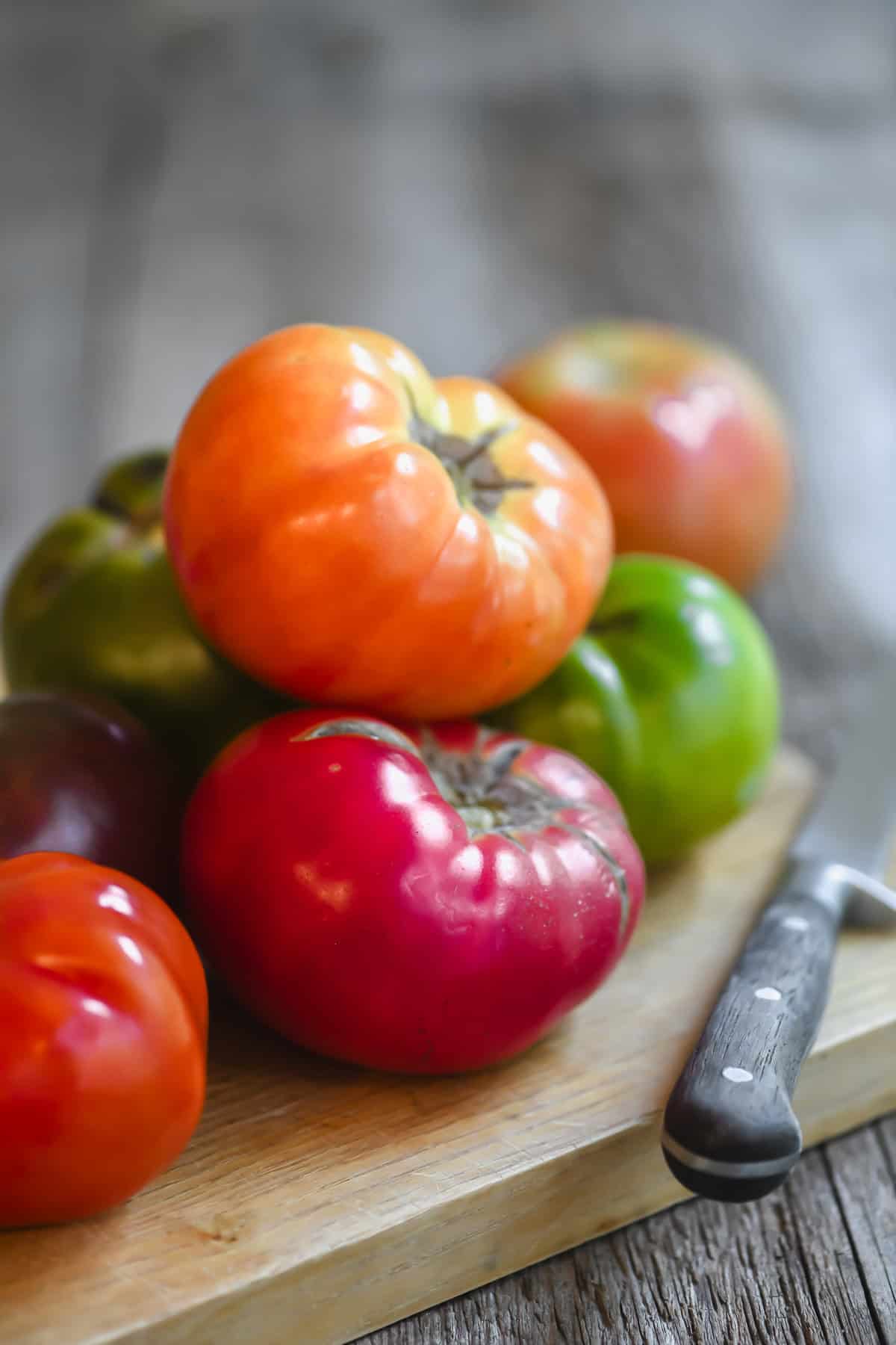 colorful heirloom tomatoes on a board.