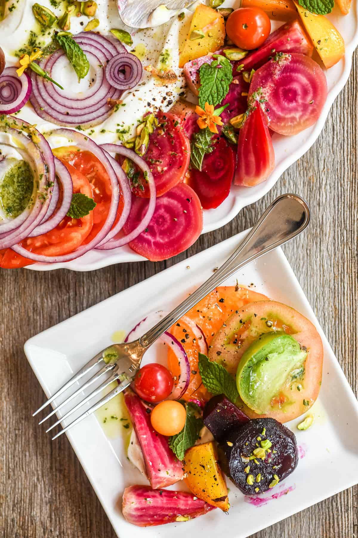 Tomato and beet composed salad with small plate on the side.