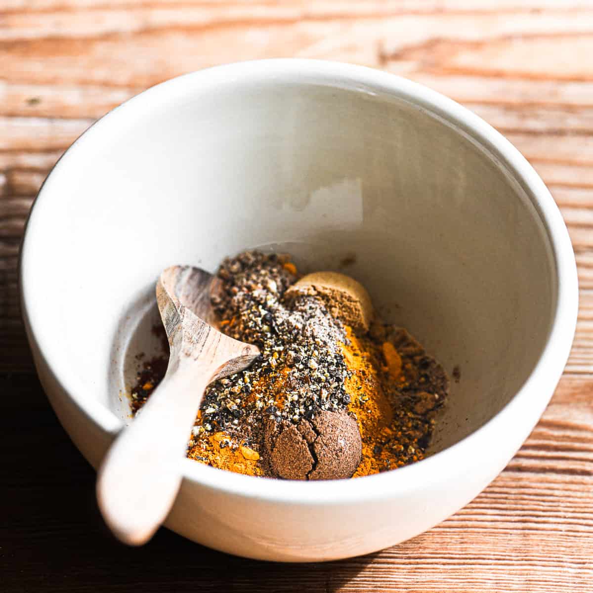 homemade ras el hanout spices in small bowl.