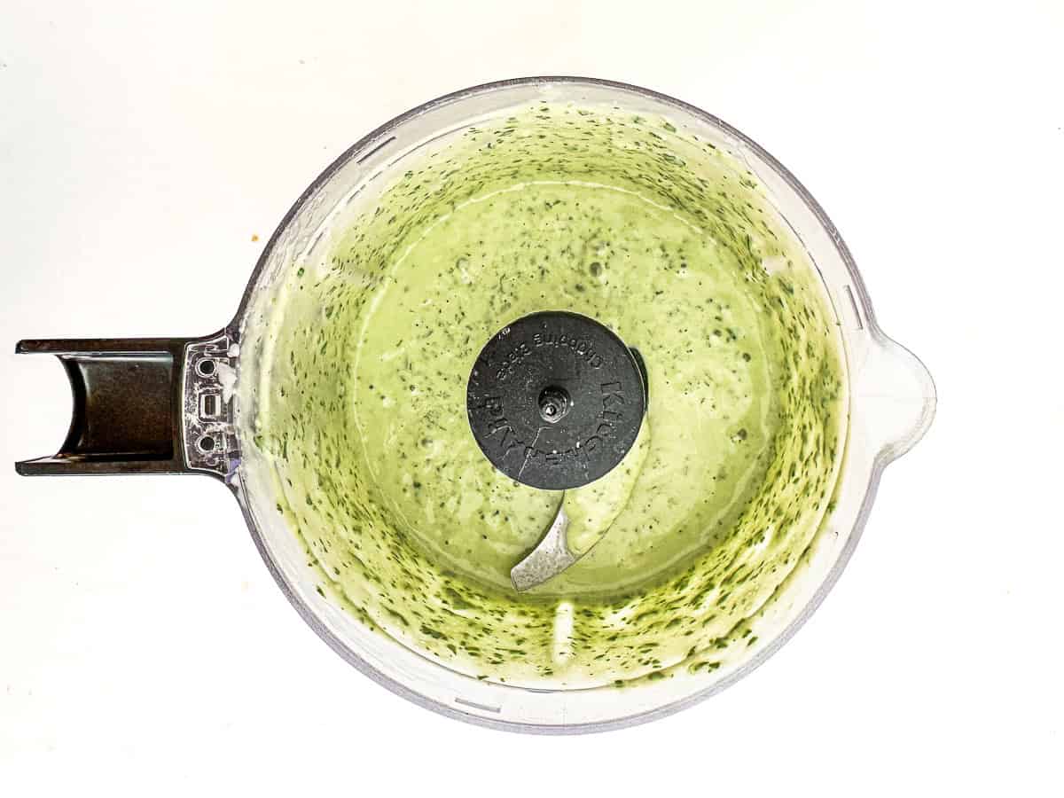Peso Caesar salad dressing blended up in a small food processor.