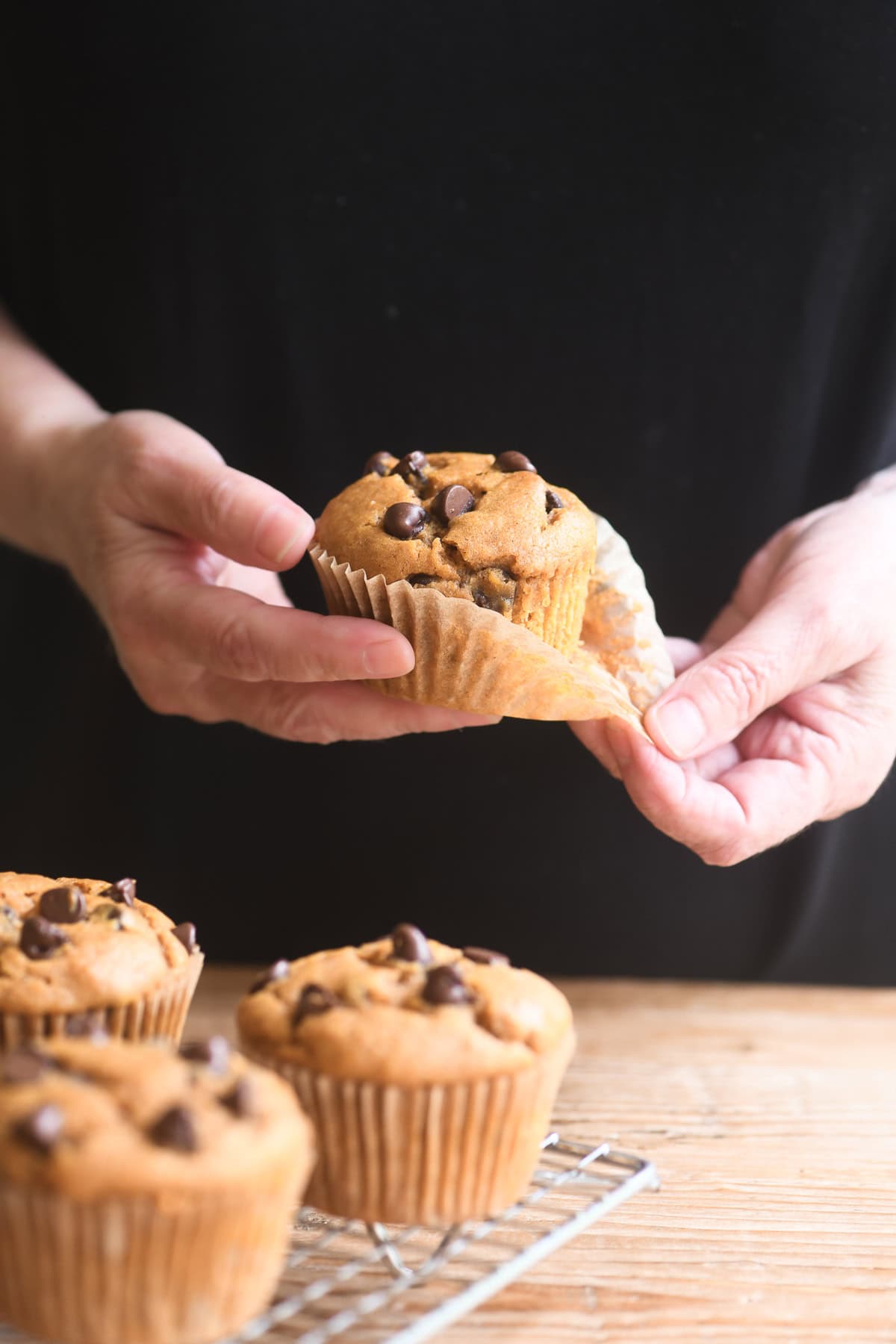 Unwrapping a chocolate chip pumpkin muffin.