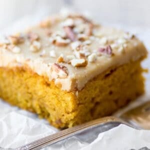 A slice of pumpkin praline cake, with fork.