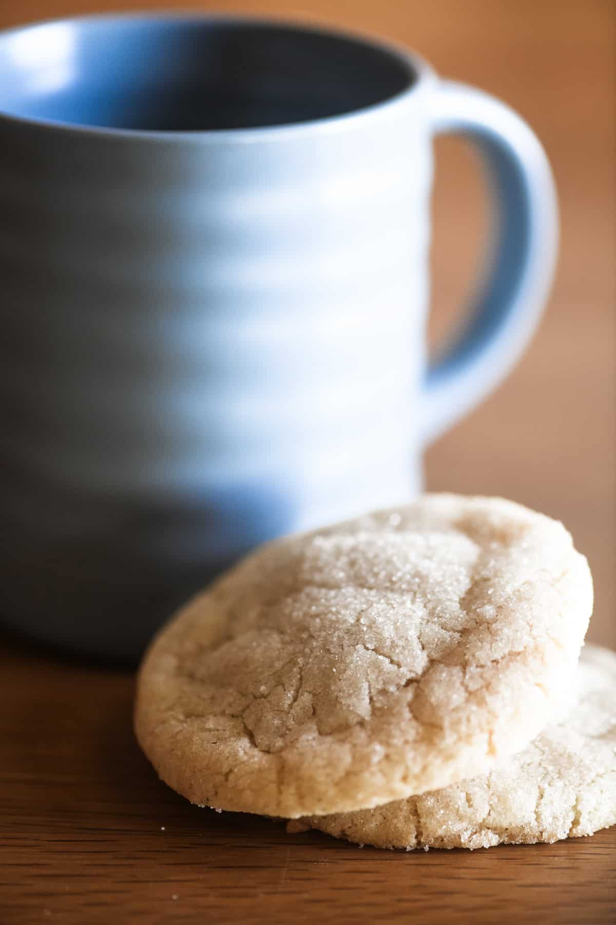 Swedish almond cardamom cookies with a blue coffee mug.
