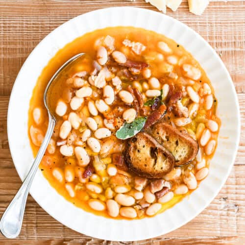 A bowl of high fiber high protein white bean and bacon soup.