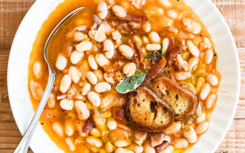 A bowl of high fiber high protein white bean and bacon soup.