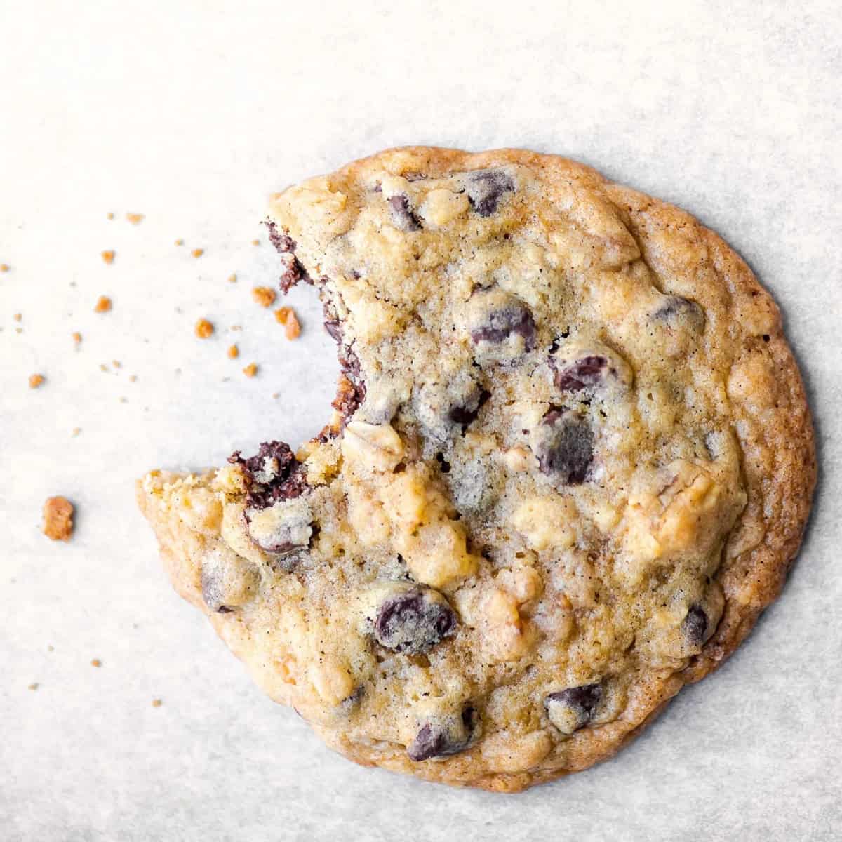 The bite shot of a chocolate chip cookie.